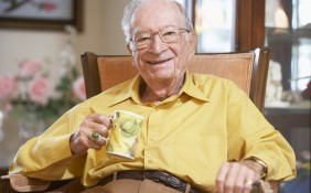 Smiling older gentleman with a cup of tea
