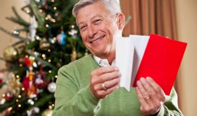 Older man opening post at Christmas