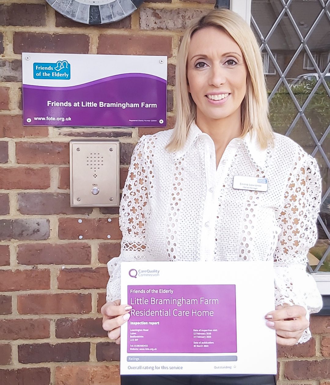 Emma Lawrance, Manager at Little Bramingham Farm care home, stood holding the 'Outstanding' CQC report