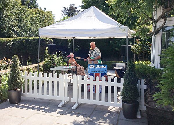 Bill Clayton performing in Redcot care home's garden for resident