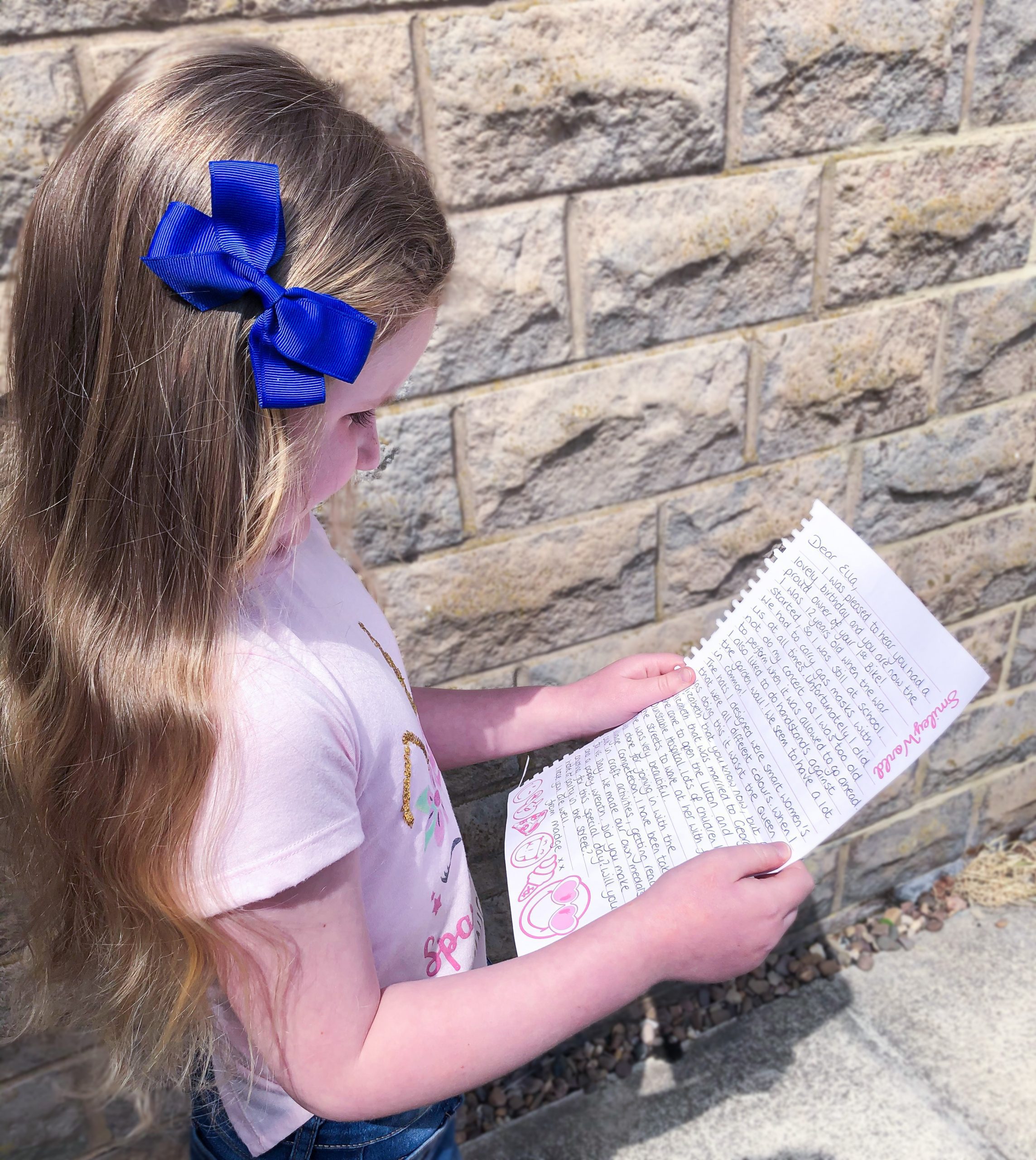 Ella reading a letter of friendship sent by Madge