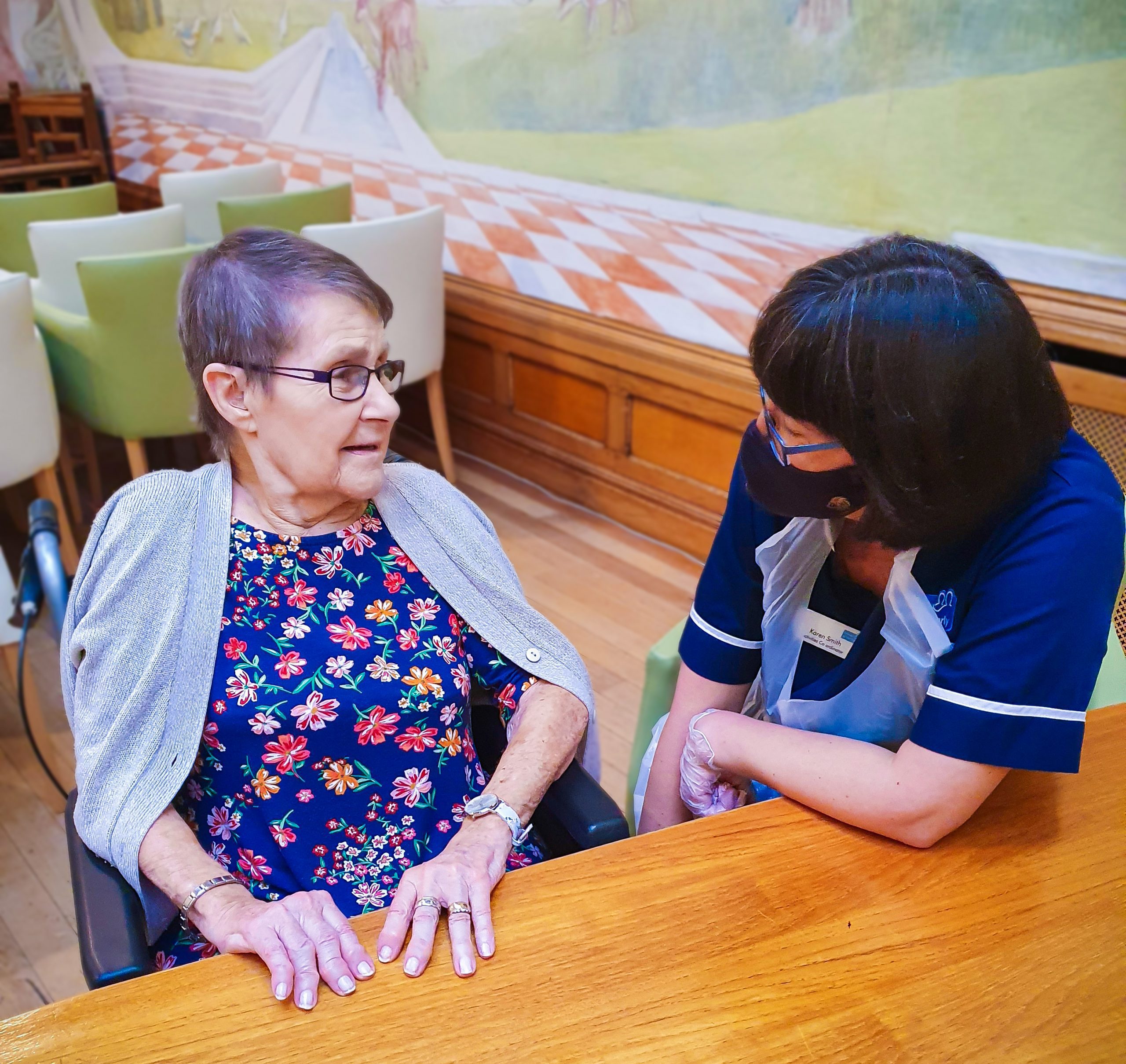 Malvern care home's activity coordinator talking to a resident