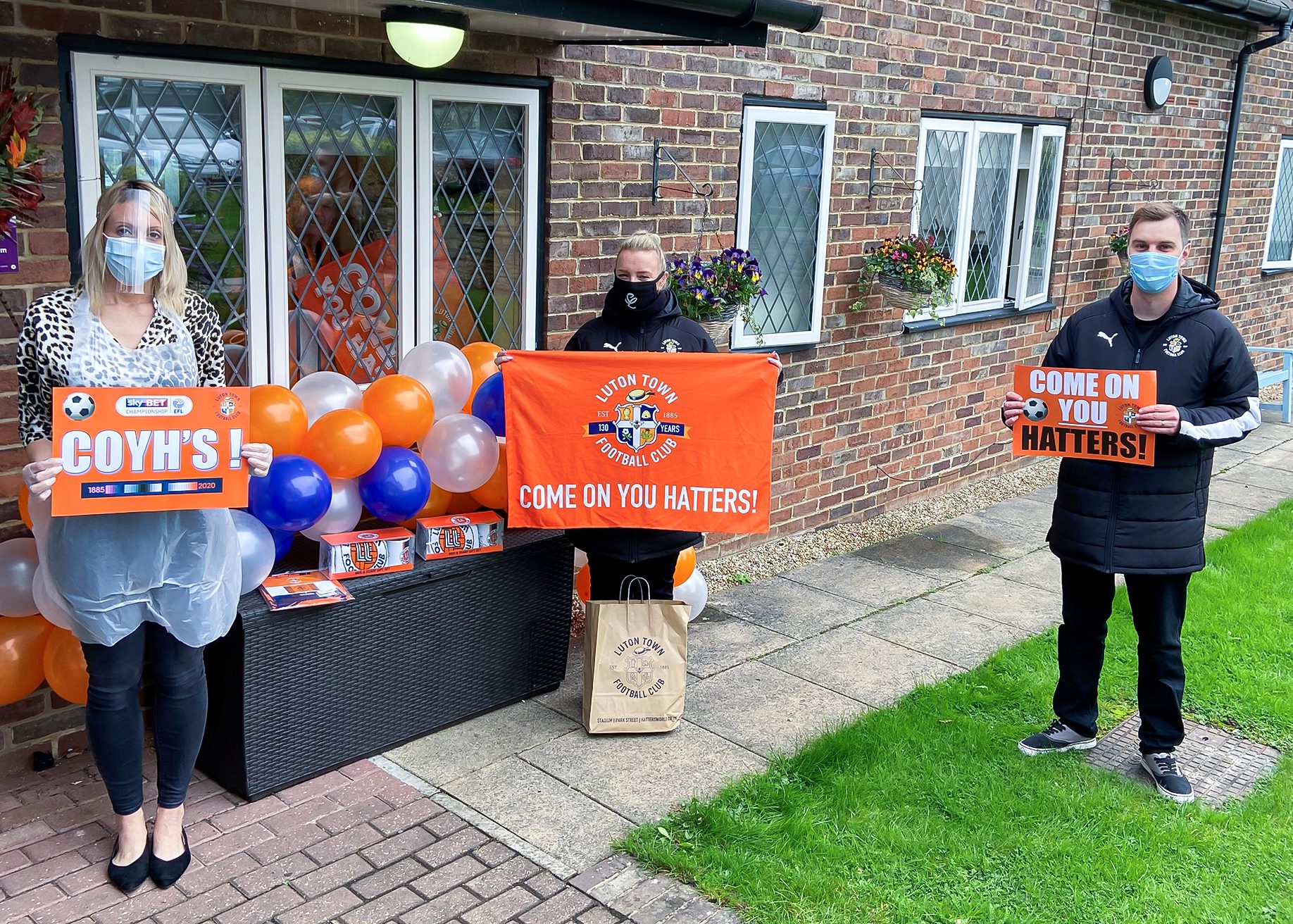 Manager of Little Bramingham Farm care home receiving the donation from Luton Town Football Club Community Trust