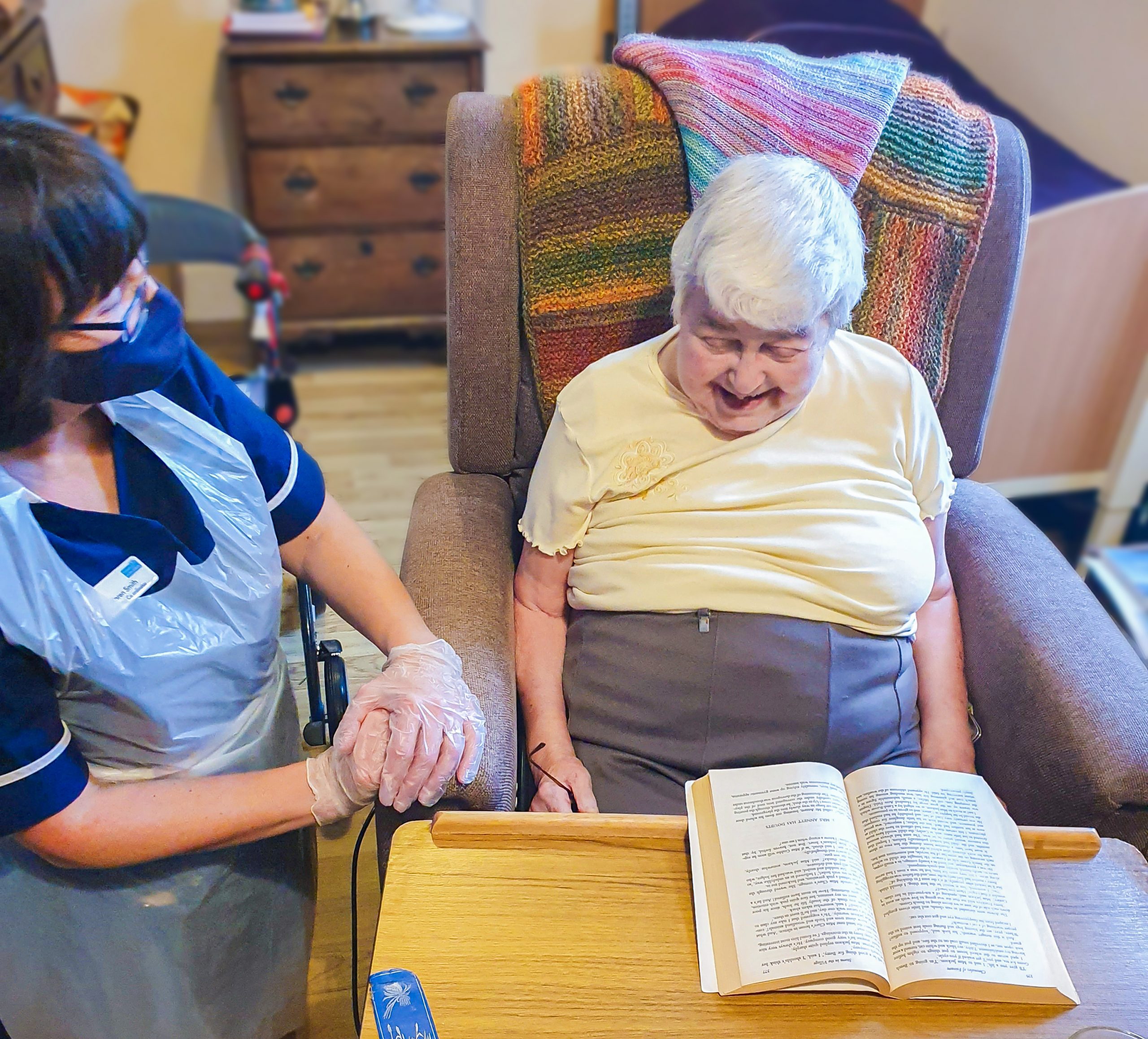 Malvern care home's activity coordinator talking to a resident