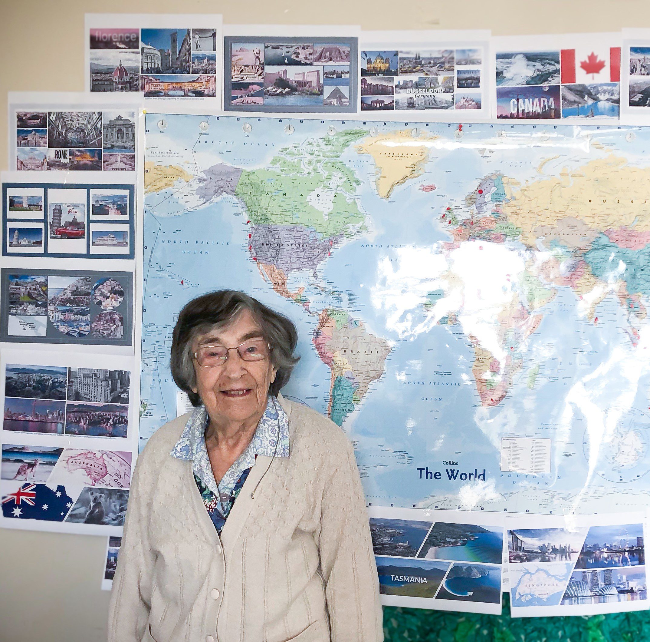 Evelyn standing in front of a world map