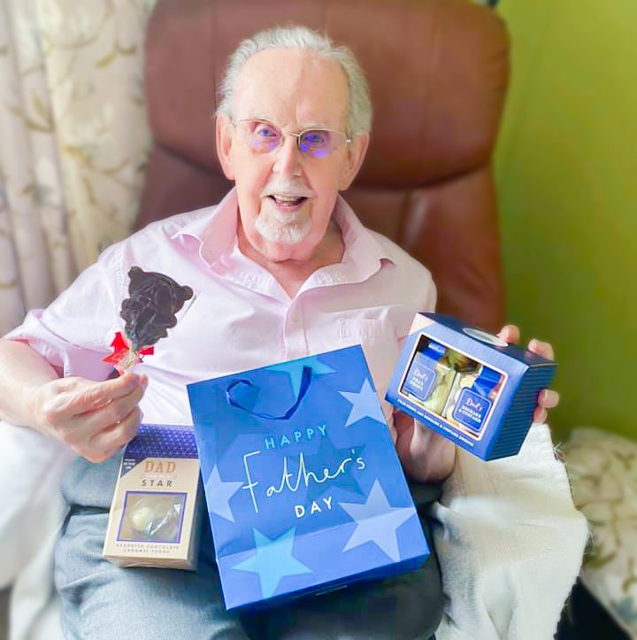 Bernard Sunley resident holding his Father's Day gifts