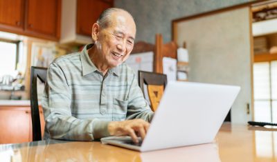 Elderly man using a laptop to stay in touch