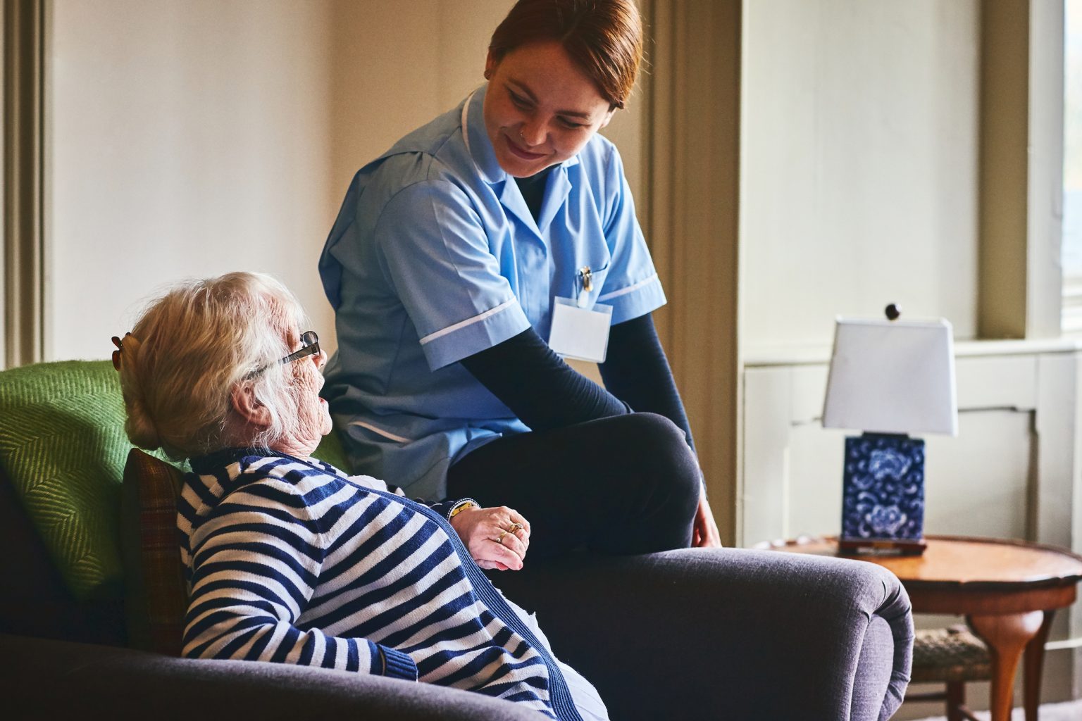 Nurse visiting senior female patient at home