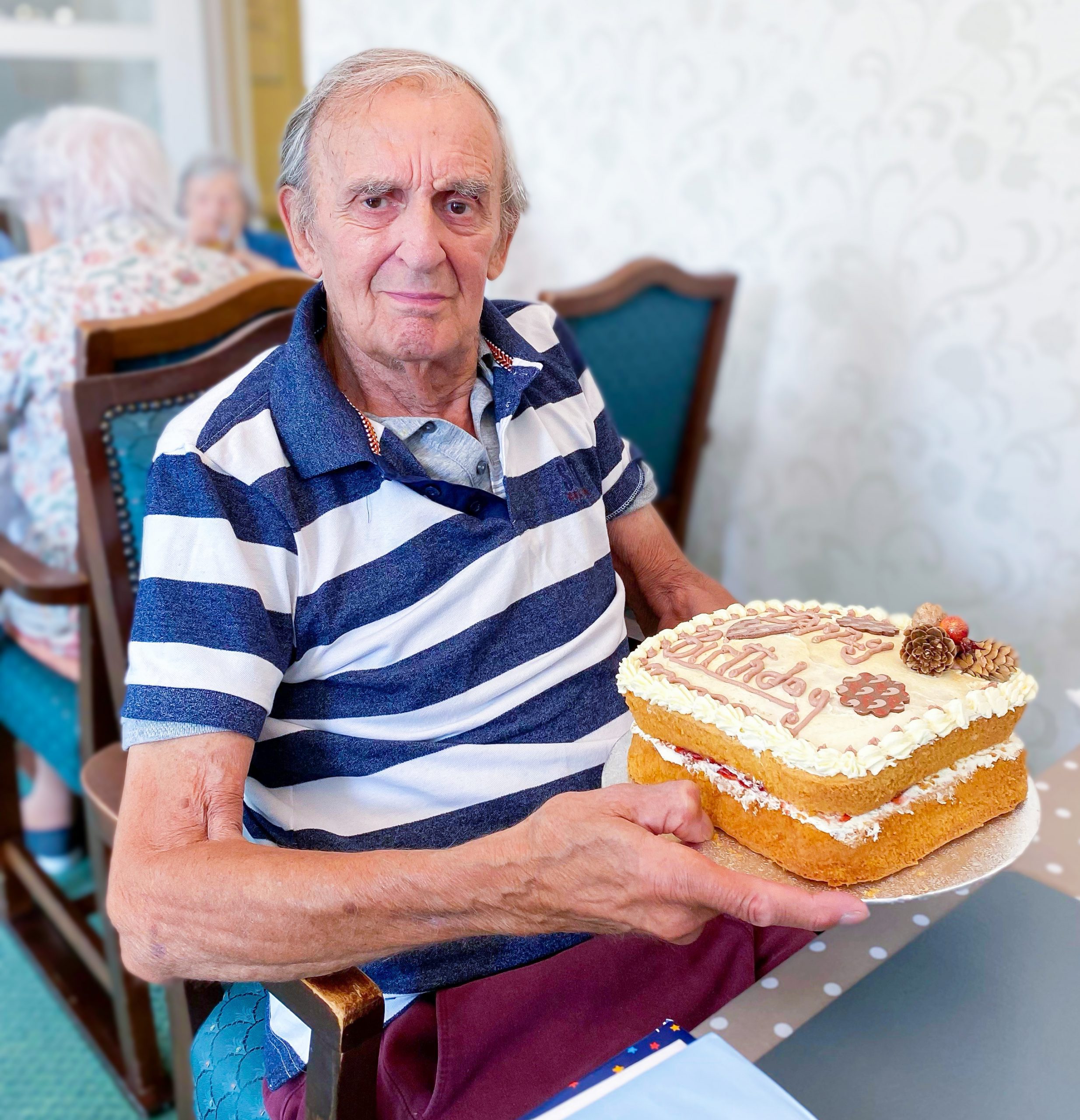 Redcot resident Keith holding a cake on his birthday.