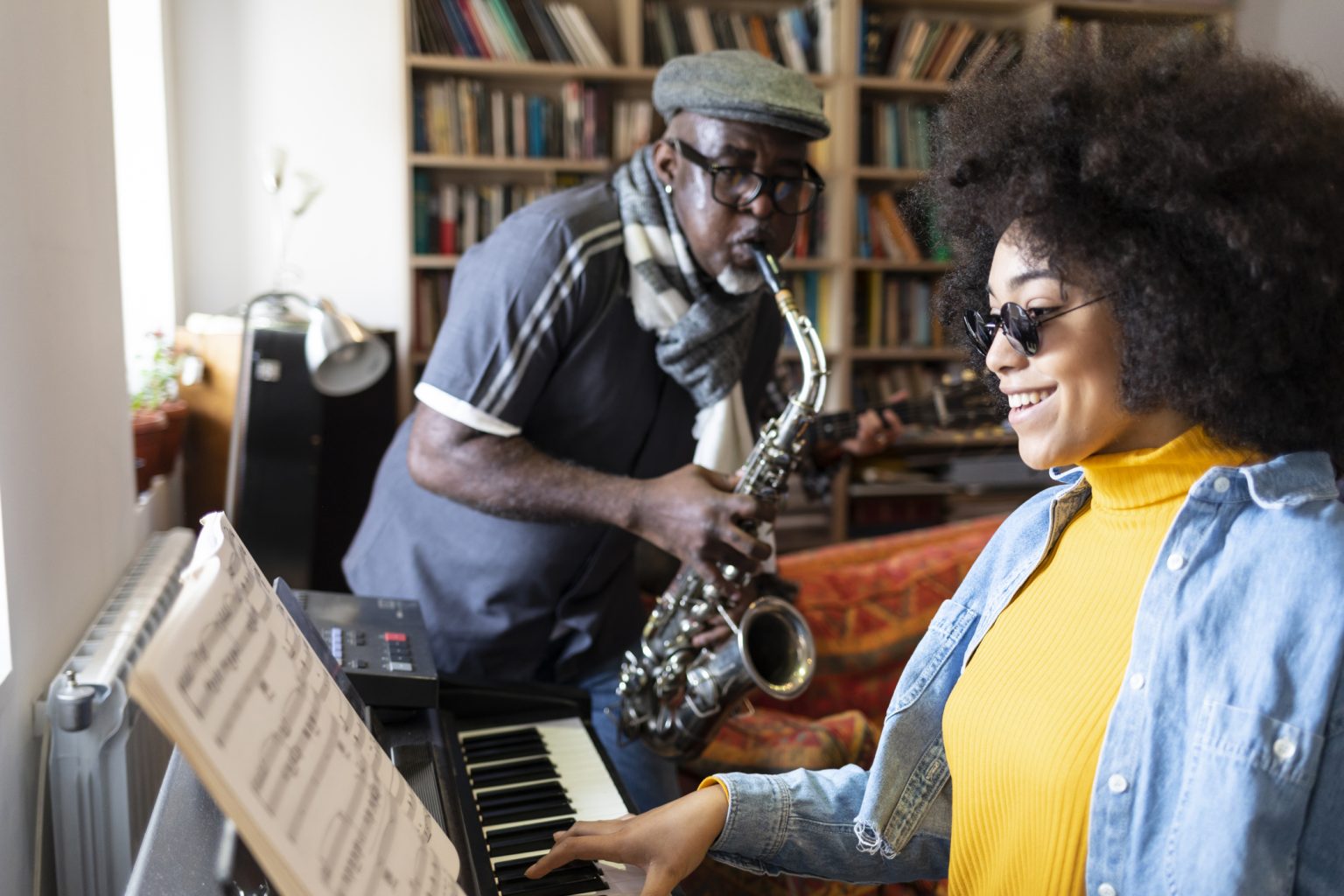 African ethnicity duo playing the piano at home