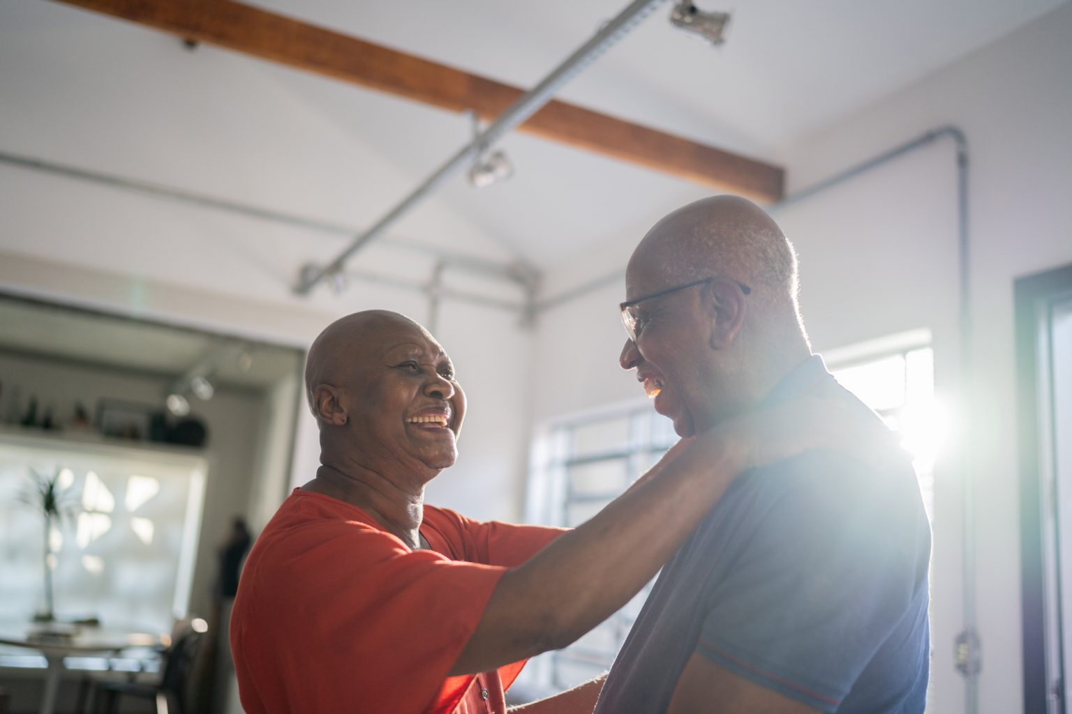 Senior couple dancing at home