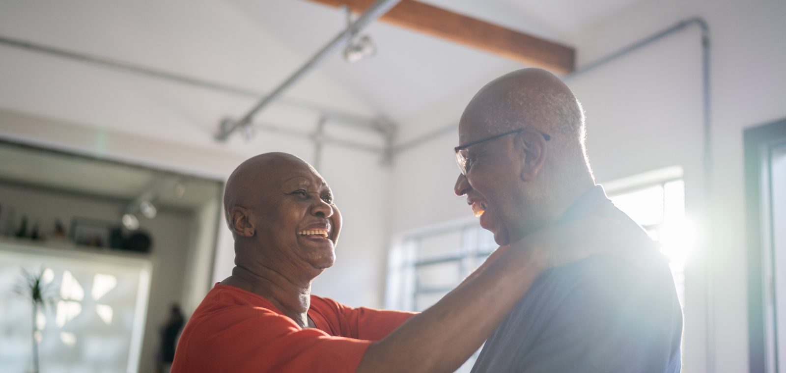 Senior couple dancing at home