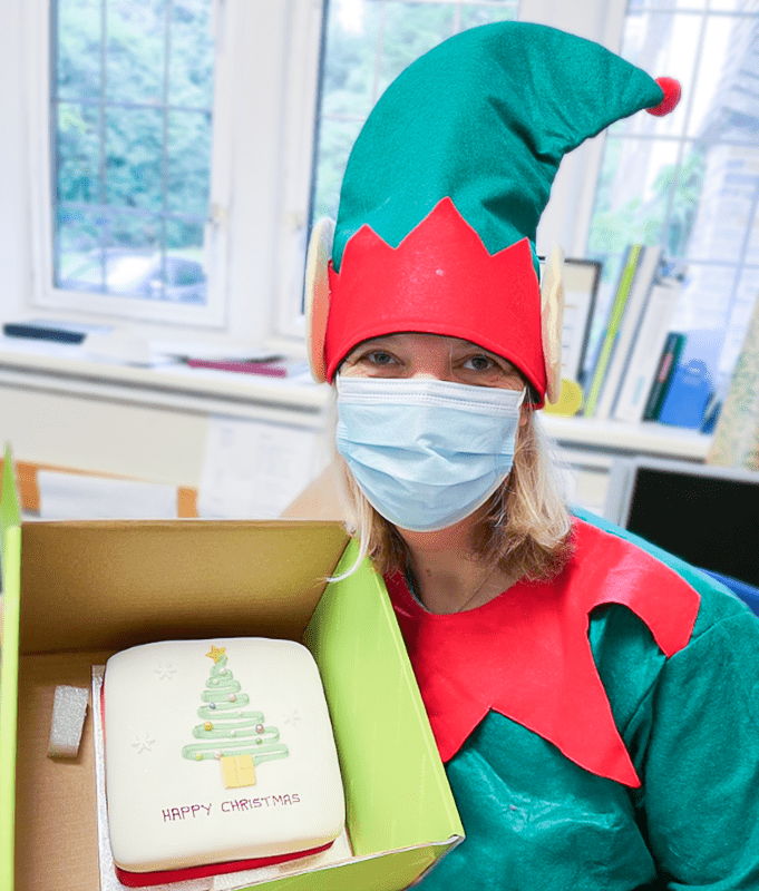 A staff memeber dressed as a Christmas Elf