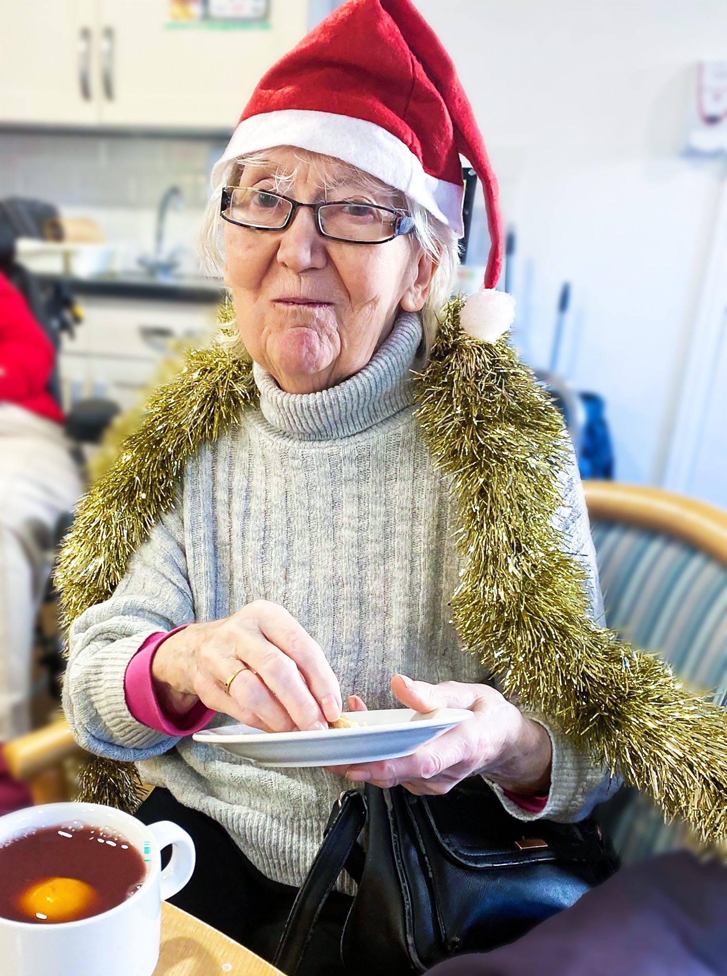 A resident at Bernard Sunley care home enjoying mulled wine during the performance
