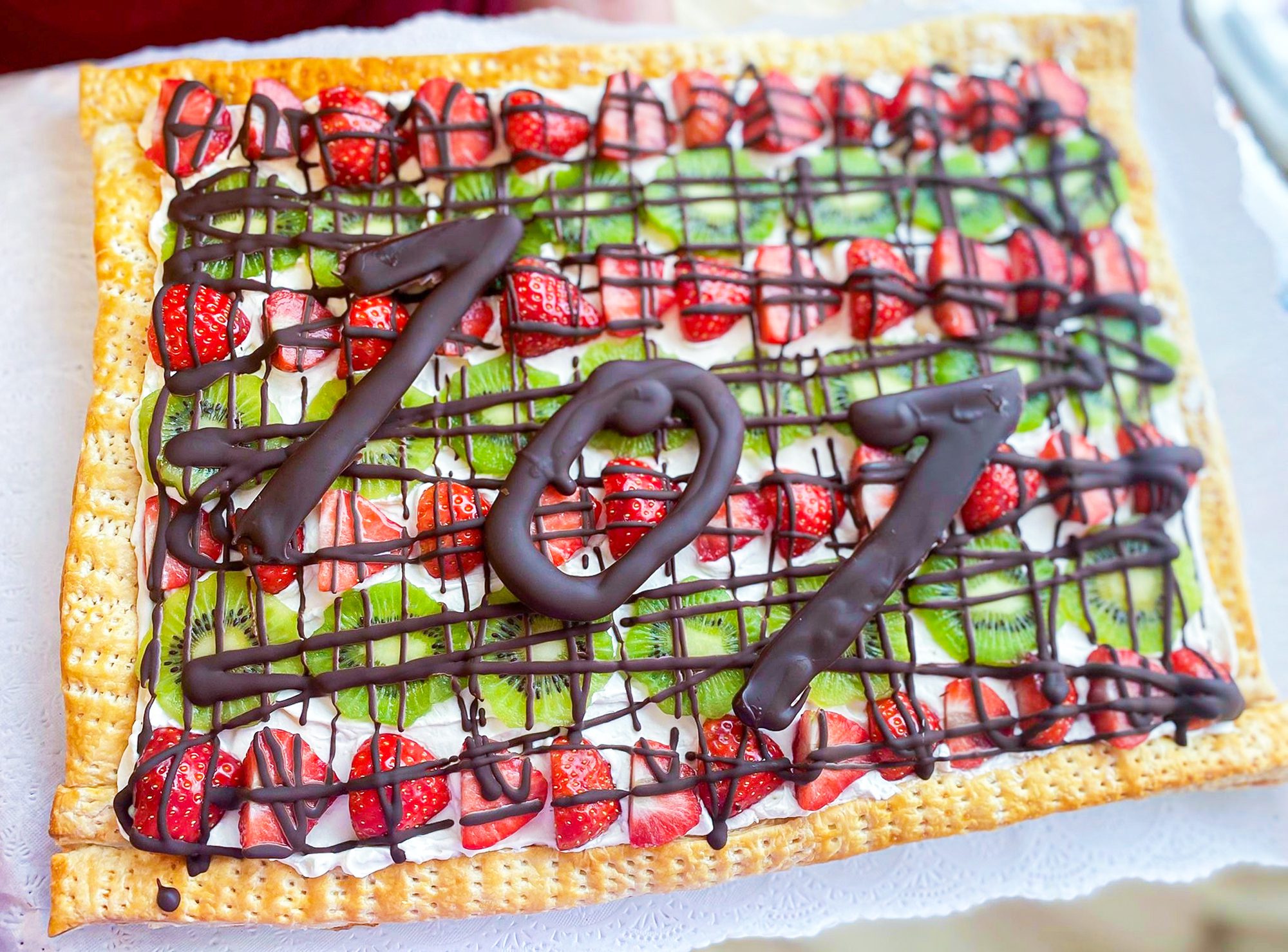 Blanche's 101st birthday cake, with strawberry and kiwi slices and drizzled with chocolate. 