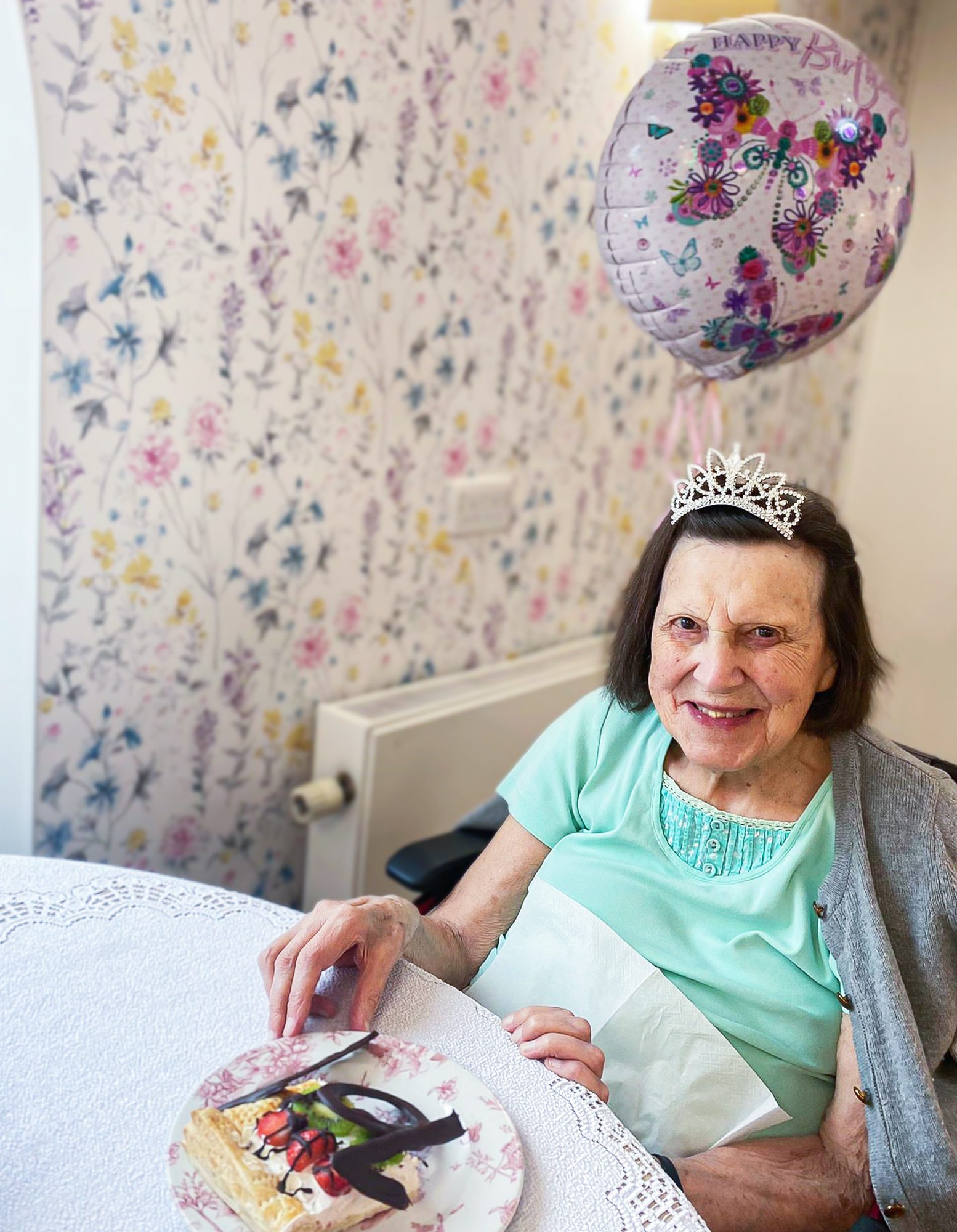 Blanche with a balloon and cake on her birthday. 