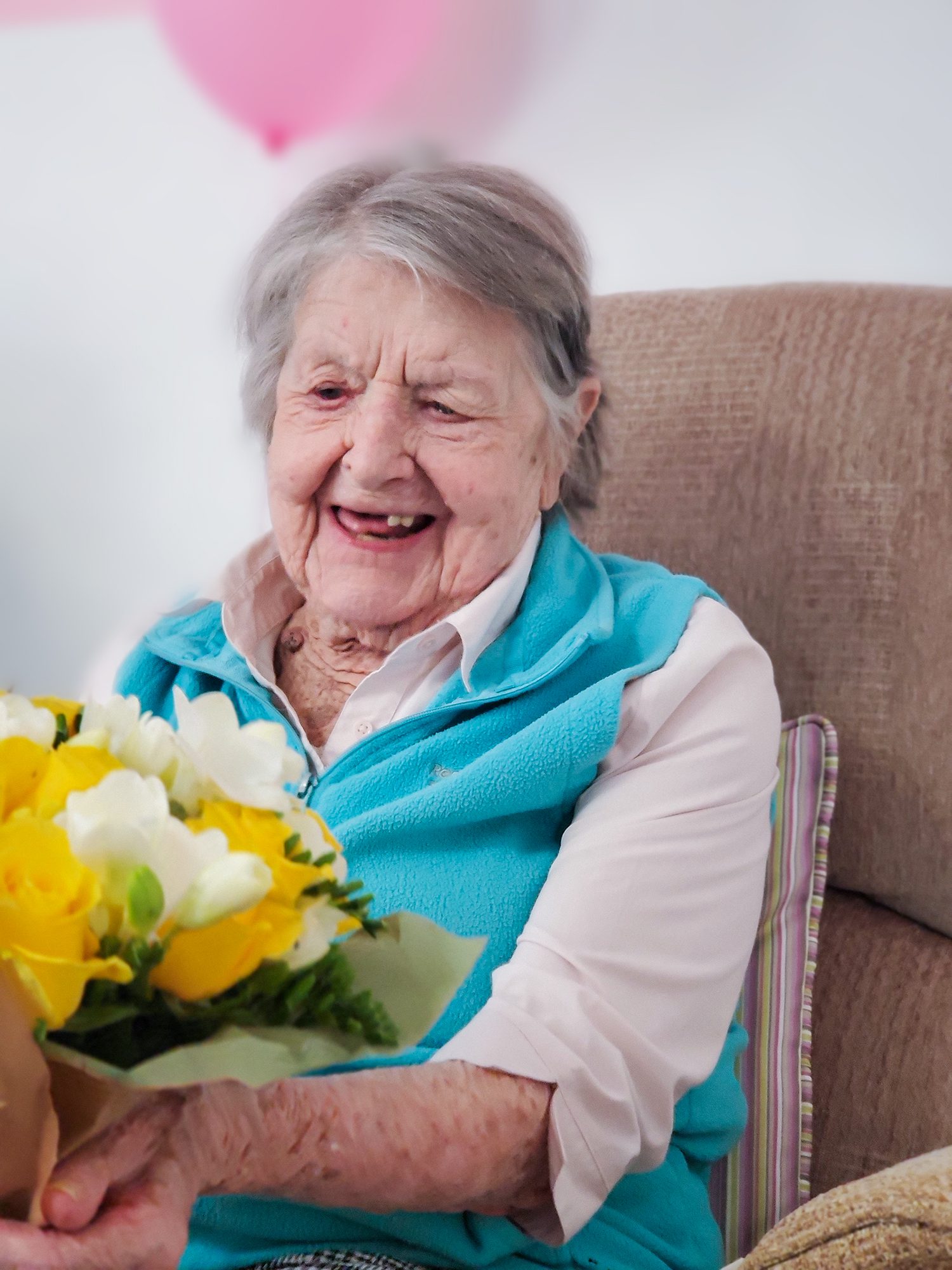 Barbara holding flowers on her birthday