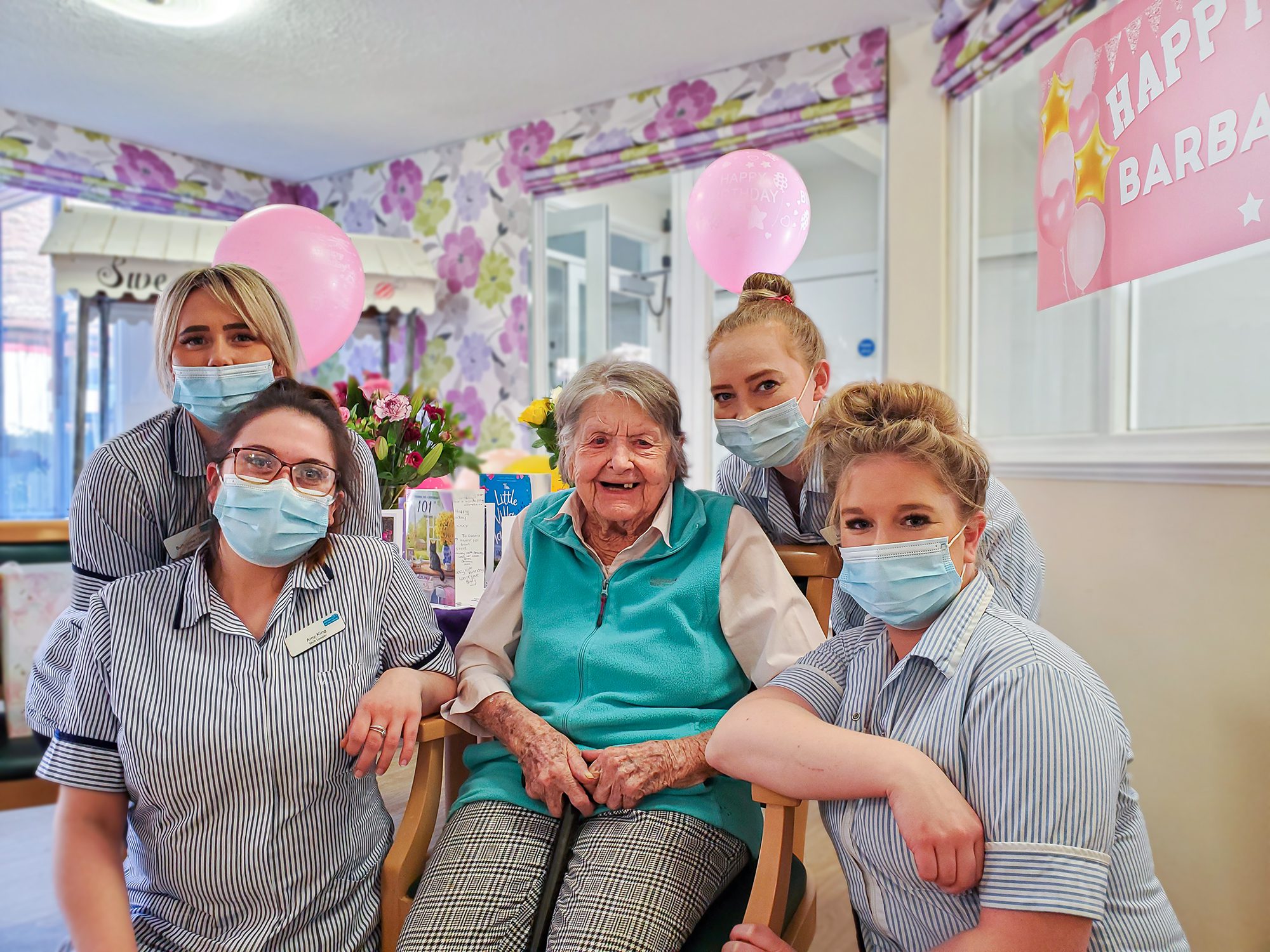 Barbara on her birthday with staff from our Essex care home, New Copford Place
