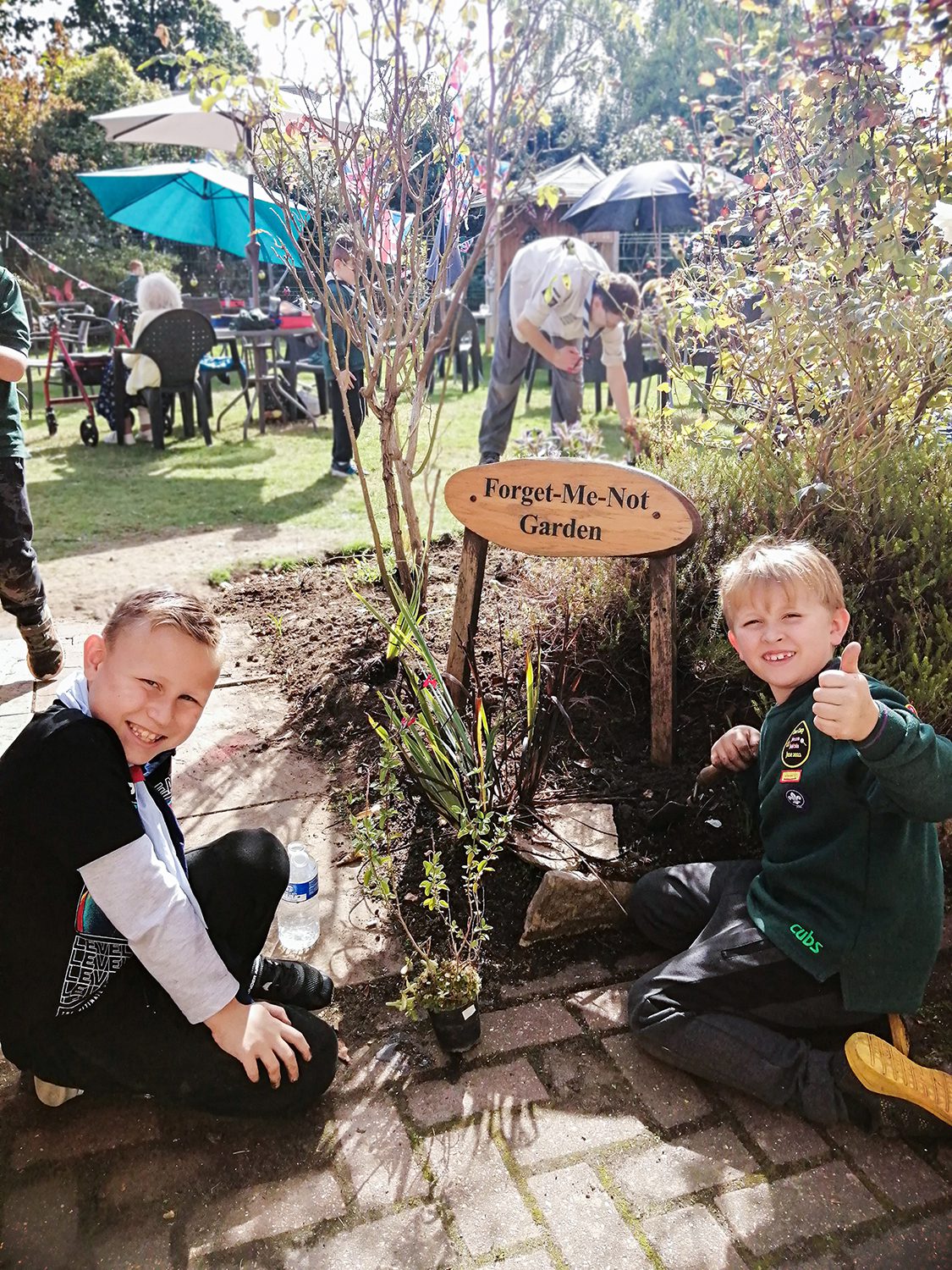 Two scouts gardening at RNNH care home