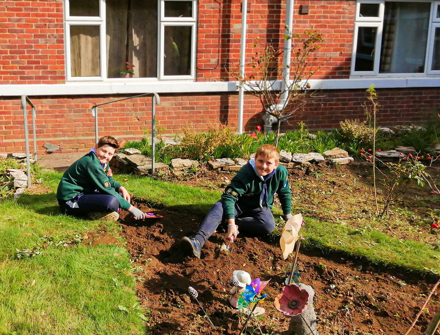 Two scouts gardening at RNNH care home