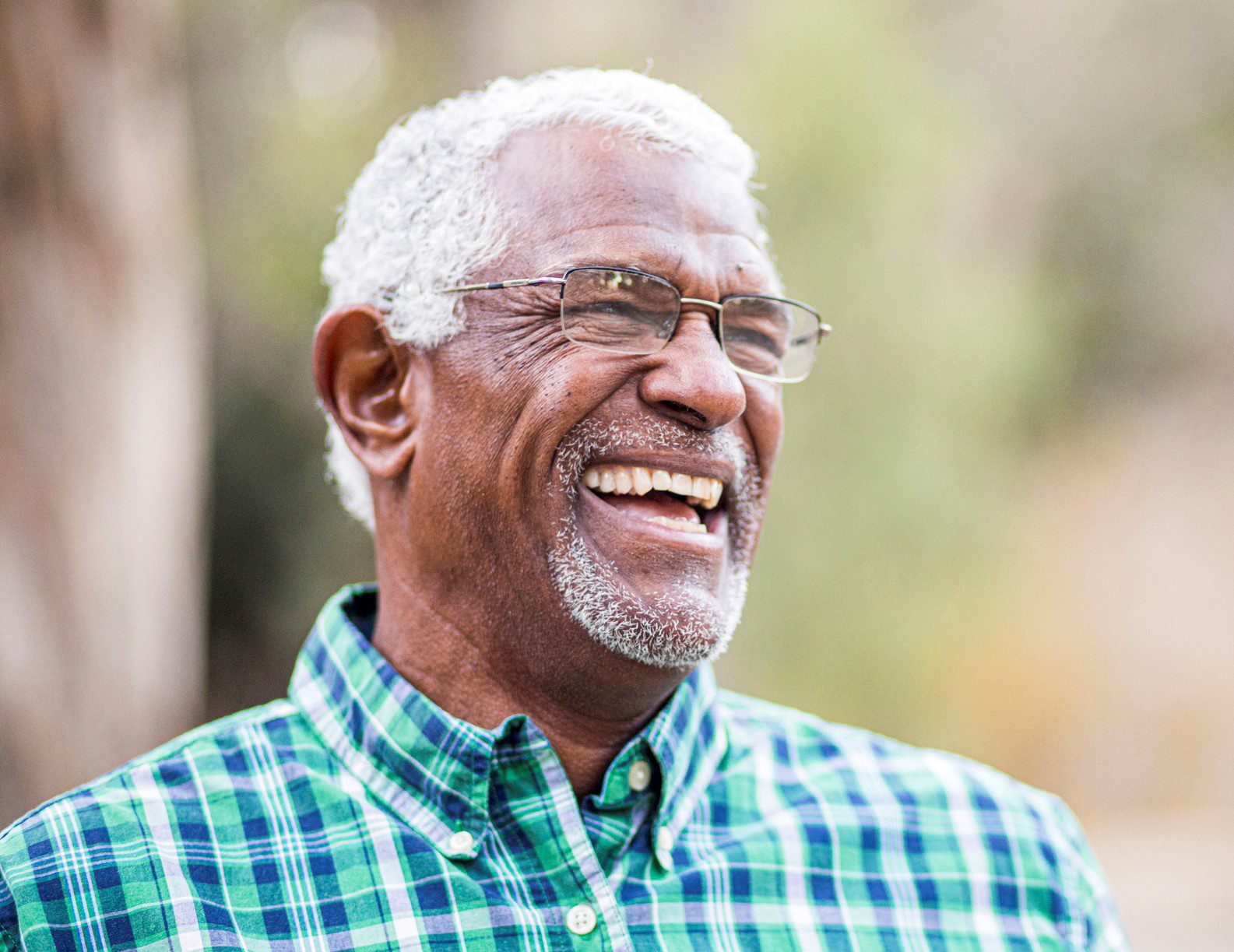 An older man smiling. 
