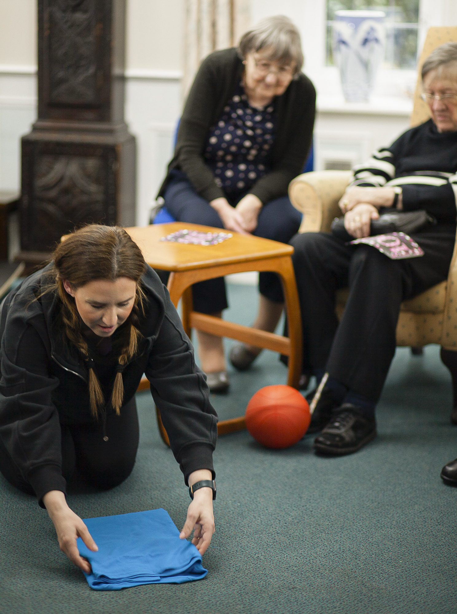 The Folding Lady Sophie Liard folding something for residents at Redcot care home.