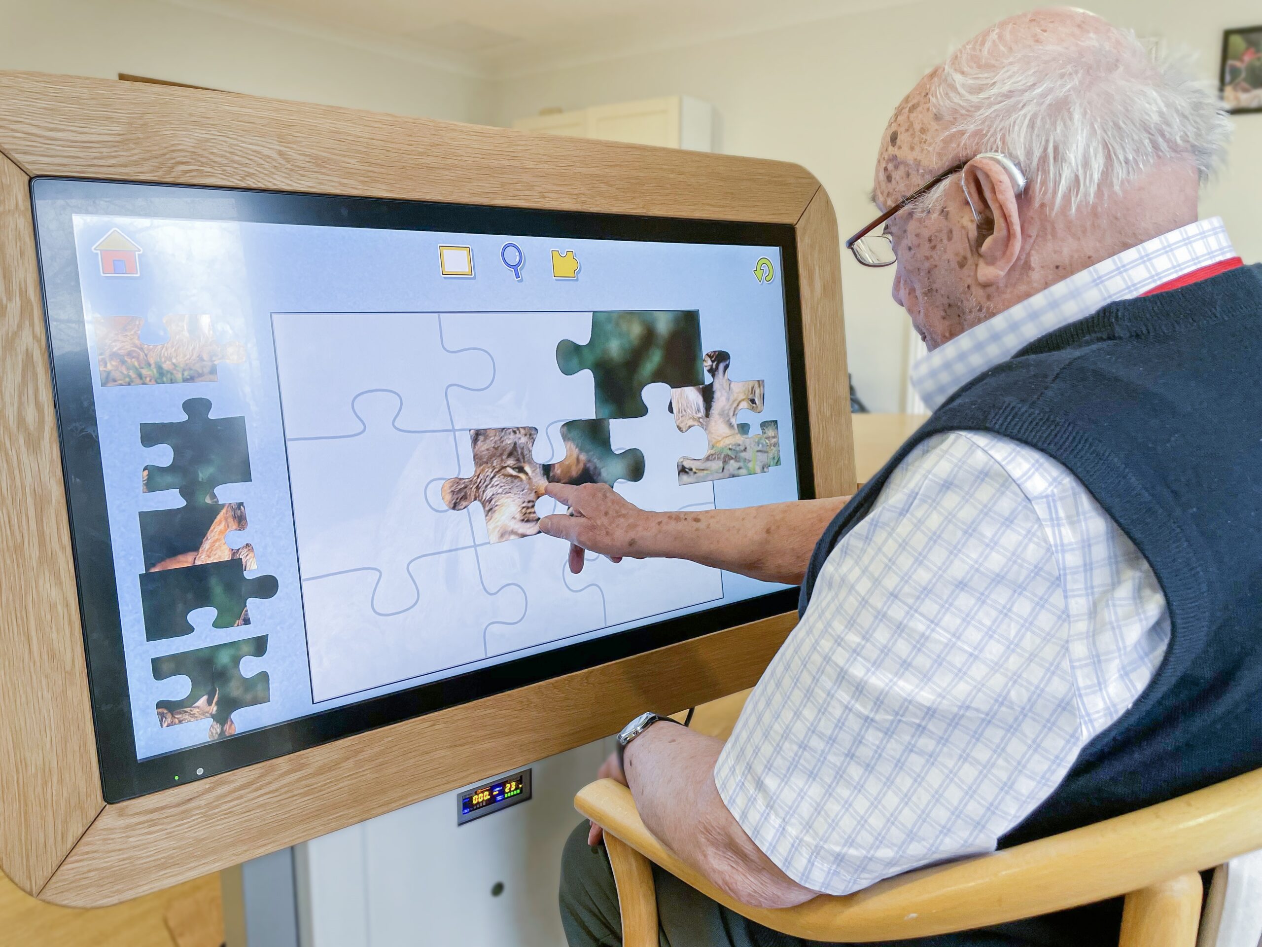 A Bernard Sunley care home resident using the interactive tablet.