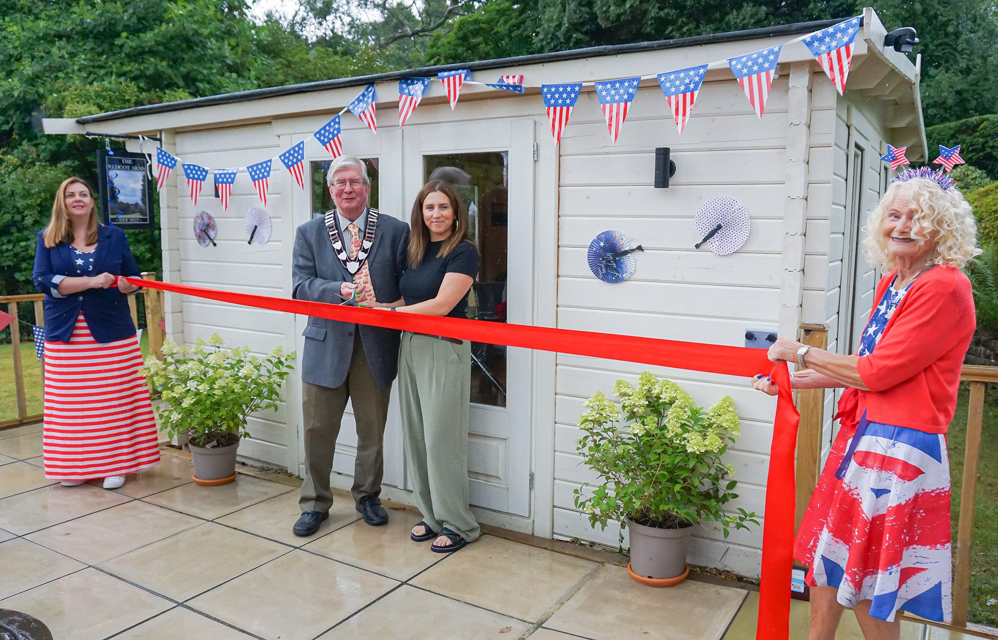 The Mayor of Haslemere, Councillor Jerome Davidson and The Folding Lady, Sophie Liard cutting the ribbon at the opening of The Redcot Arms.