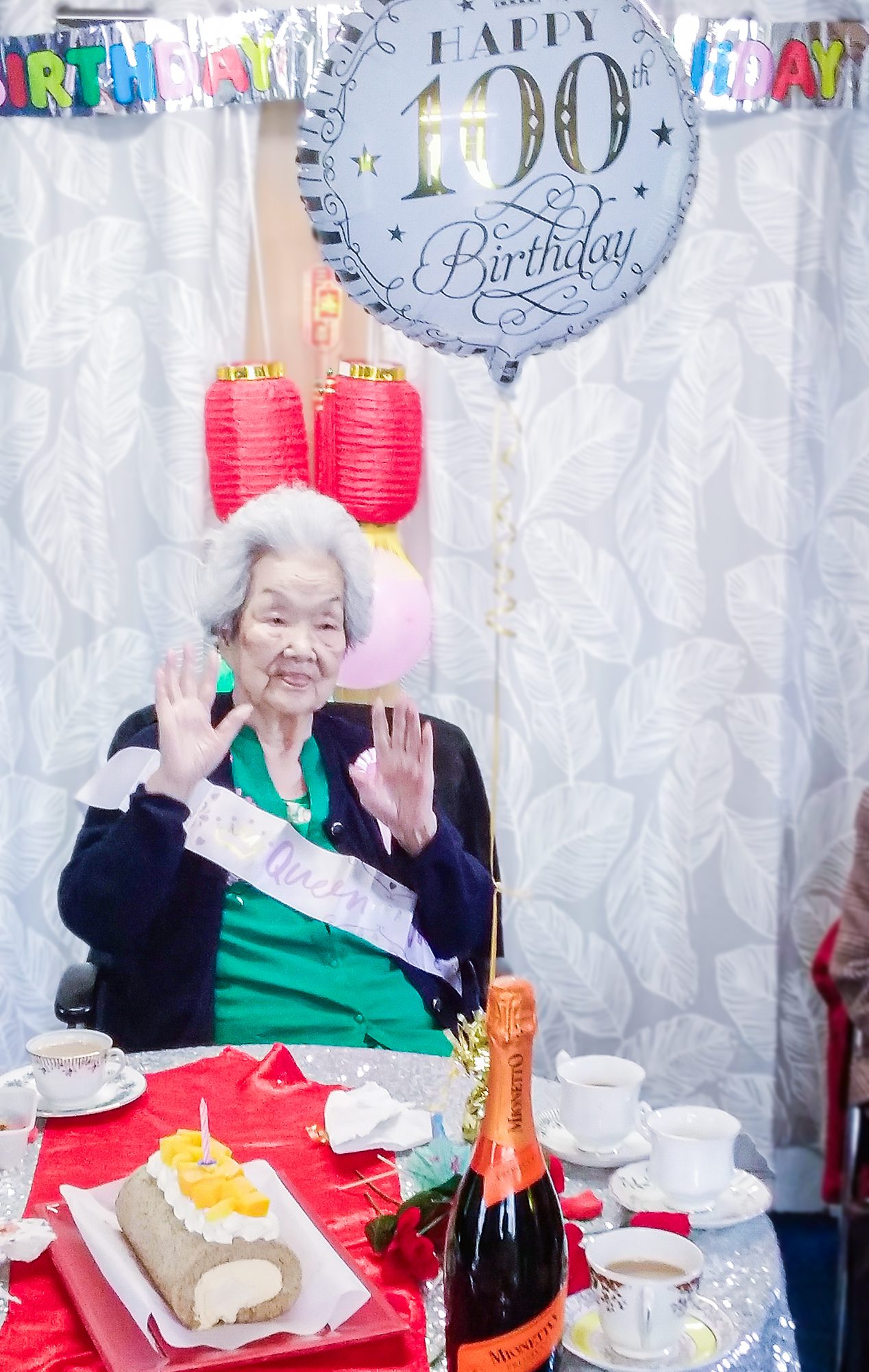 Dance loving Norma on her 100th birthday surrounded by cake and balloons