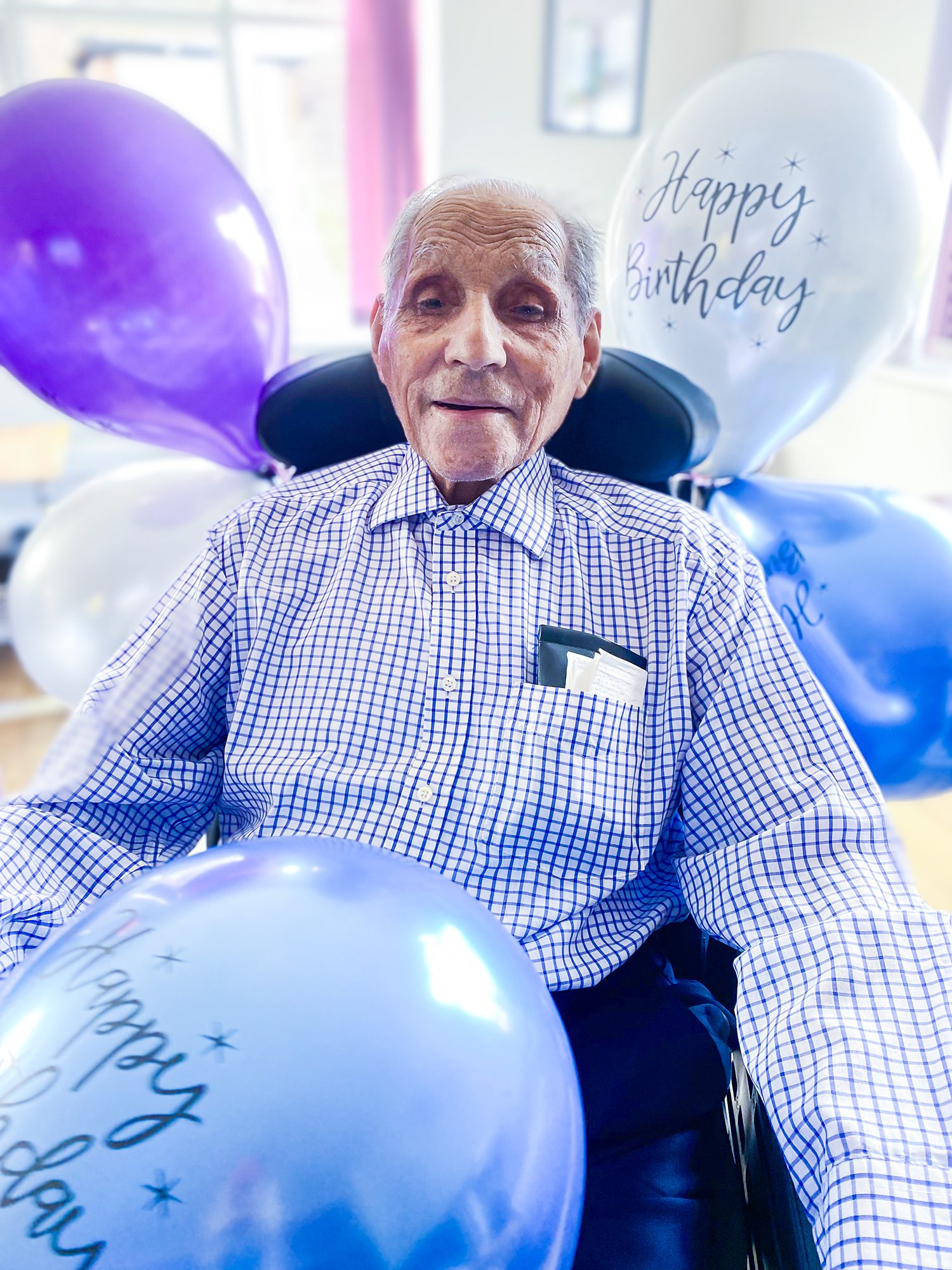 Cedric surrounded by balloons on his 101st Birthday.
