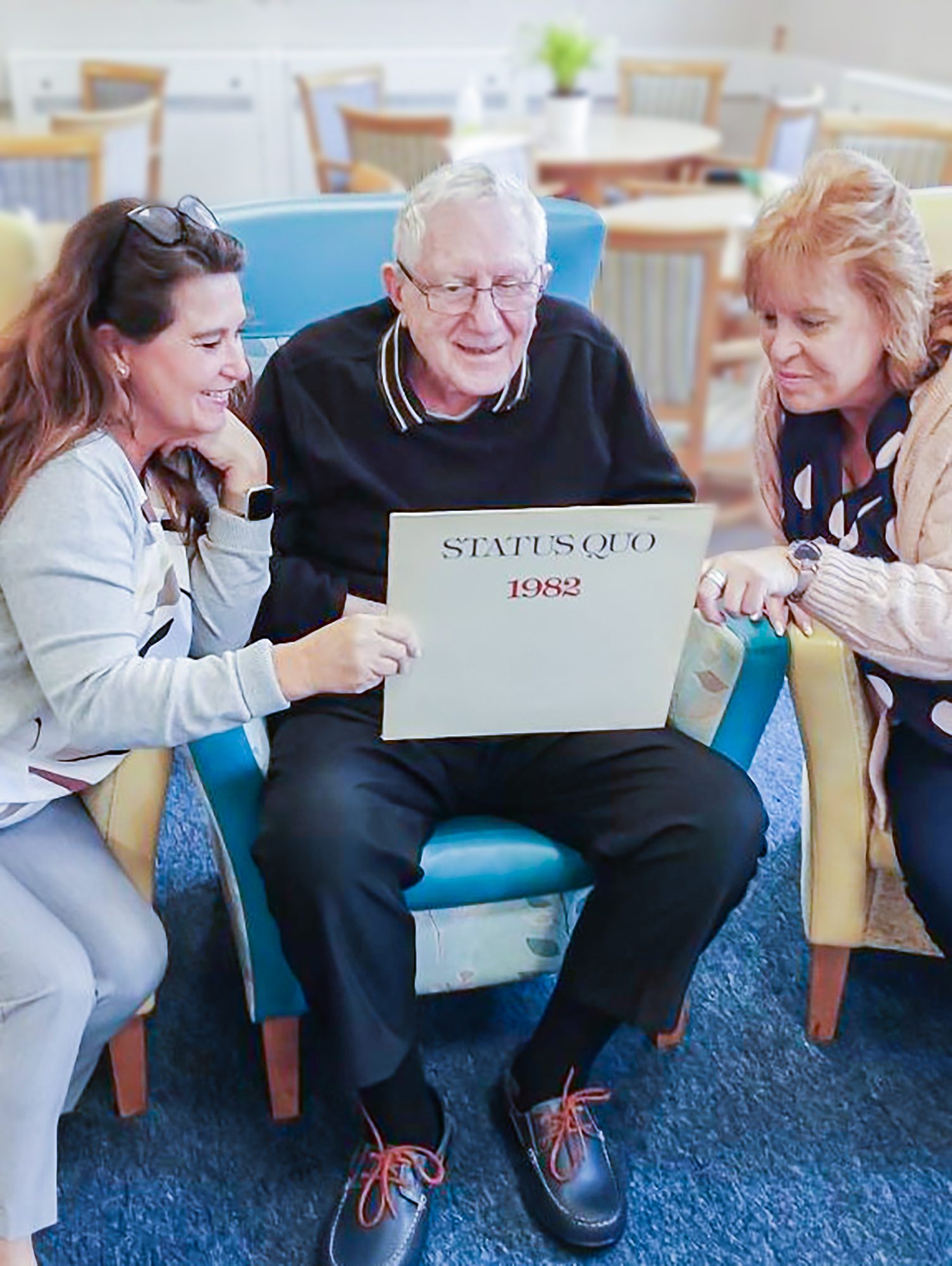 Shirley, Leonard and Wendy looking at the Status Quo album.