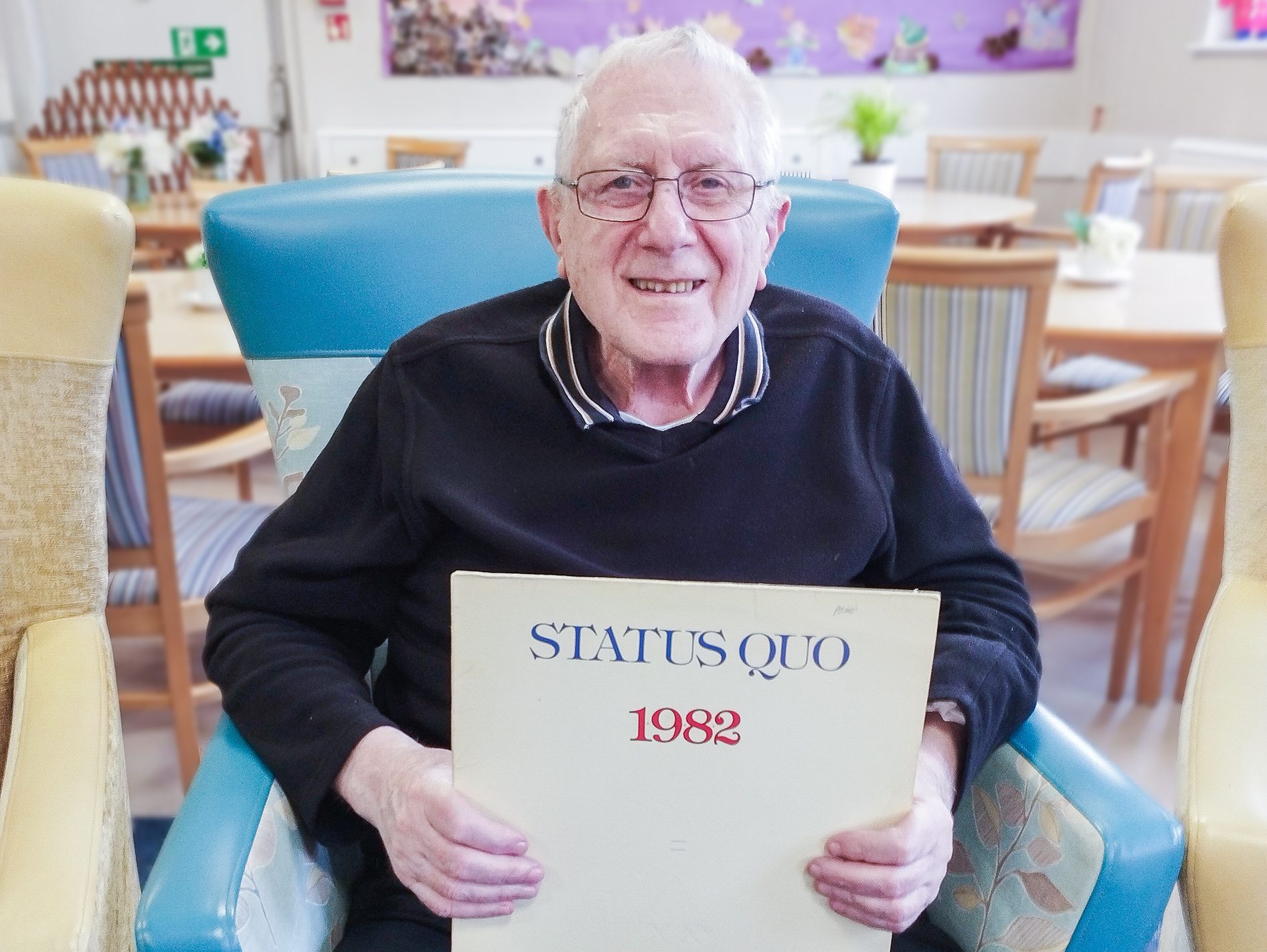 Leonard holding a Status Quo record.