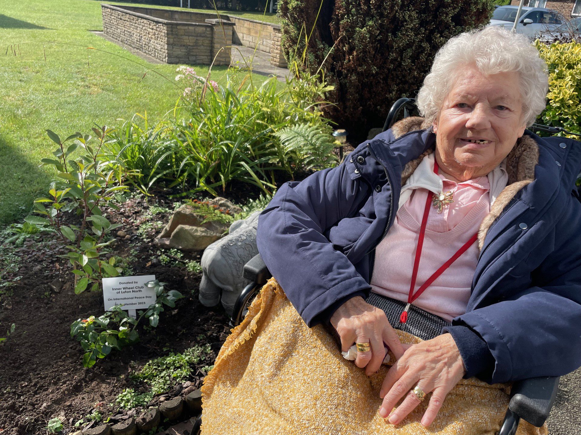 Luton resident Margaret Alison next to the peace rose. 