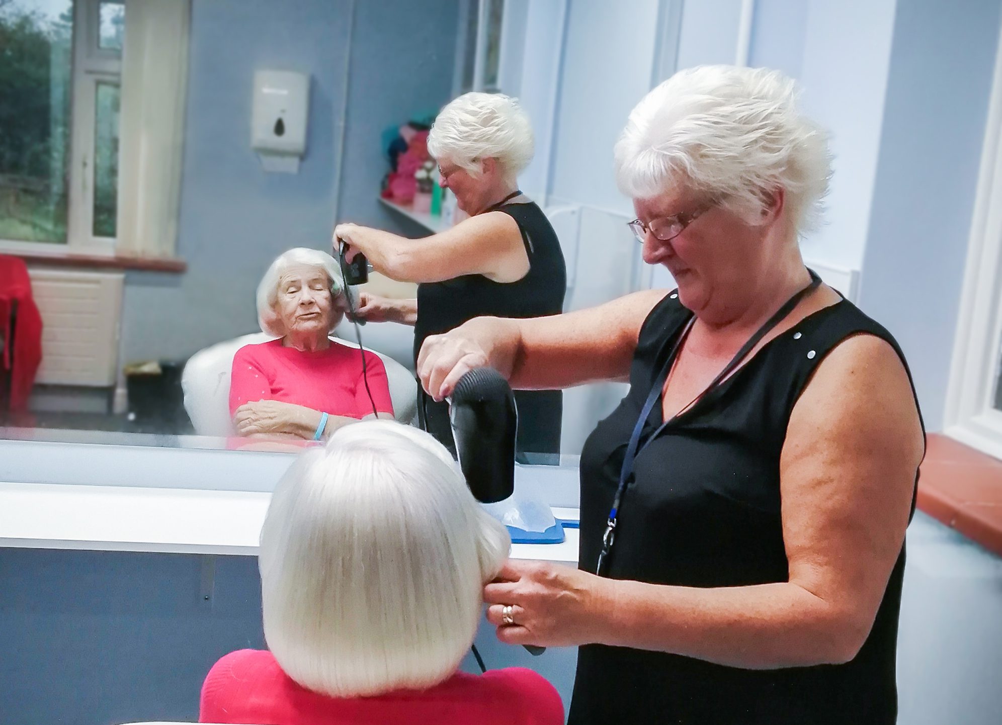 2023 November Highlights - Lynda doing a resident's hair.