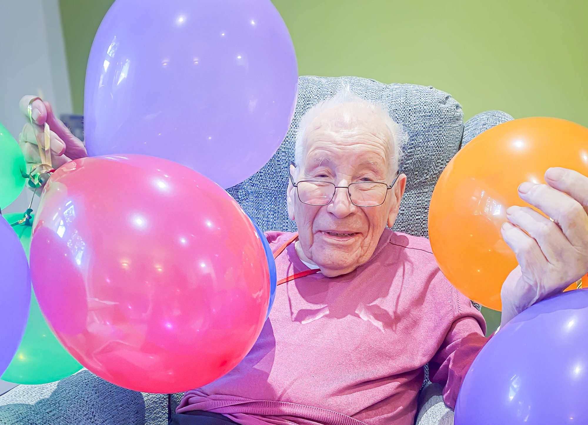 Alan on his birthday holding balloons.