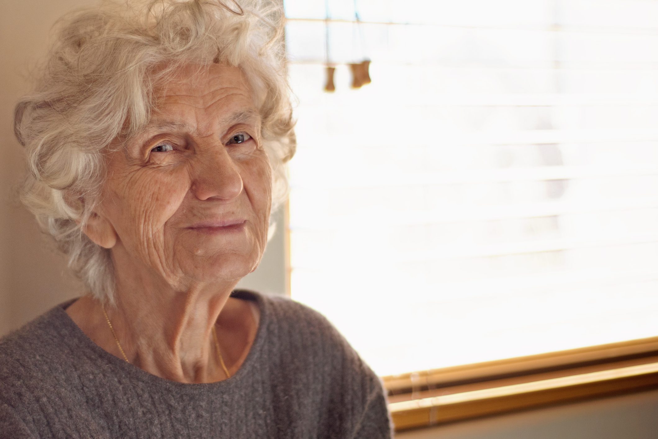 Stock image of an older woman smiling used for our Winter Appeal.