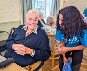 Alan telling a member of staff a joke 