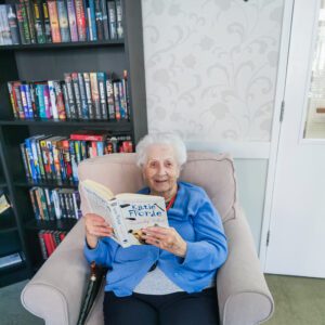 A resident on World Book Day holding a book. 