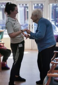 A resident dancing with a Rise staff member.