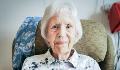 Essex care home resident Sylvia smiling at the camera.