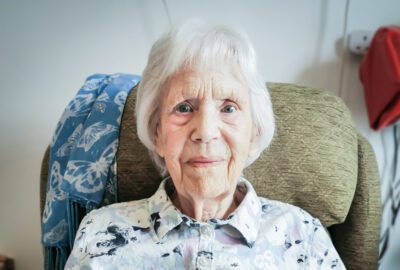 Essex care home resident Sylvia smiling at the camera.