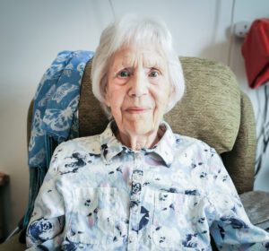 New Copford Place care home resident Sylvia smiling at the camera. Used for a story about sisters at our Essex care home.