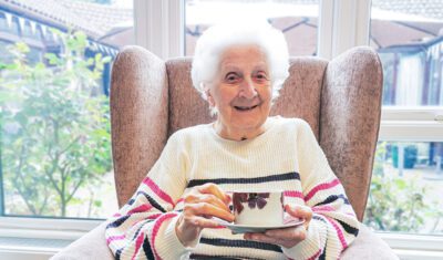 New Copford Place care home resident, Pat, enjoying a good cup of tea on National Tea Day