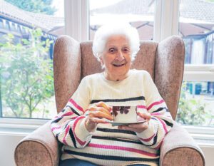 New Copford Place care home resident, Pat, enjoying a good cup of tea on National Tea Day