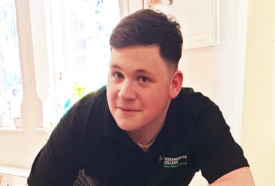 Keelan, who volunteers at Kidderminster Day Care, smiling at the camera.
