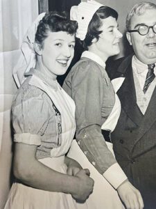 An old black and white photo of Jill when she was a nurse, stood with another nurse.