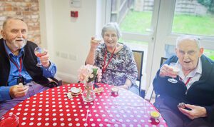 Three residents toast cocktails at the Jazz Cafe