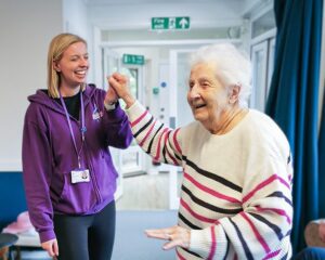 Libb and New Copford Place care home resident Pat dance together.