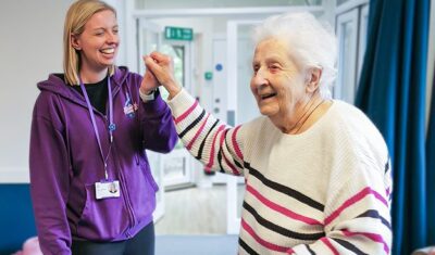 Libb and New Copford Place care home resident Pat dance together.